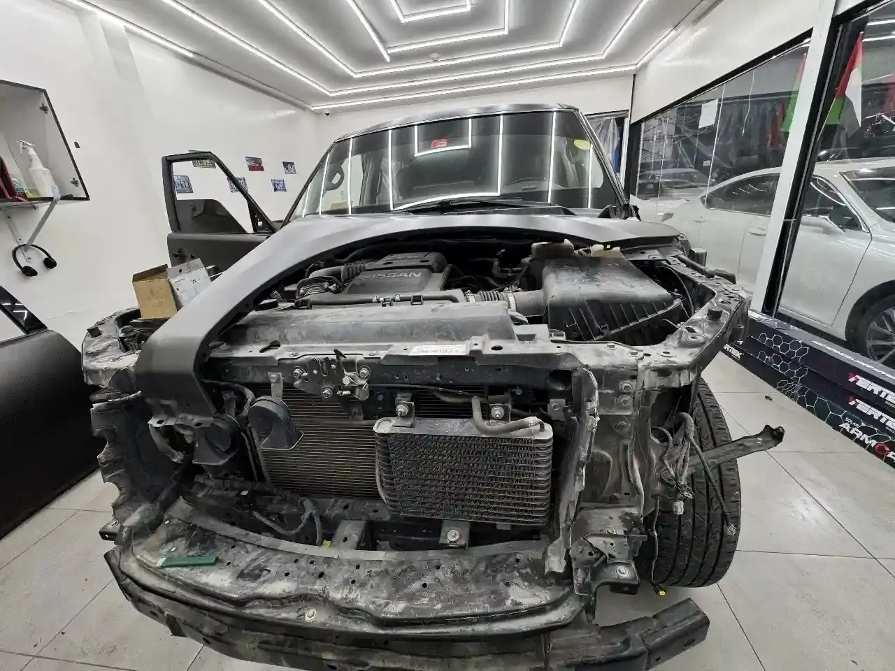A vehicle with its front end stripped for paint protection film